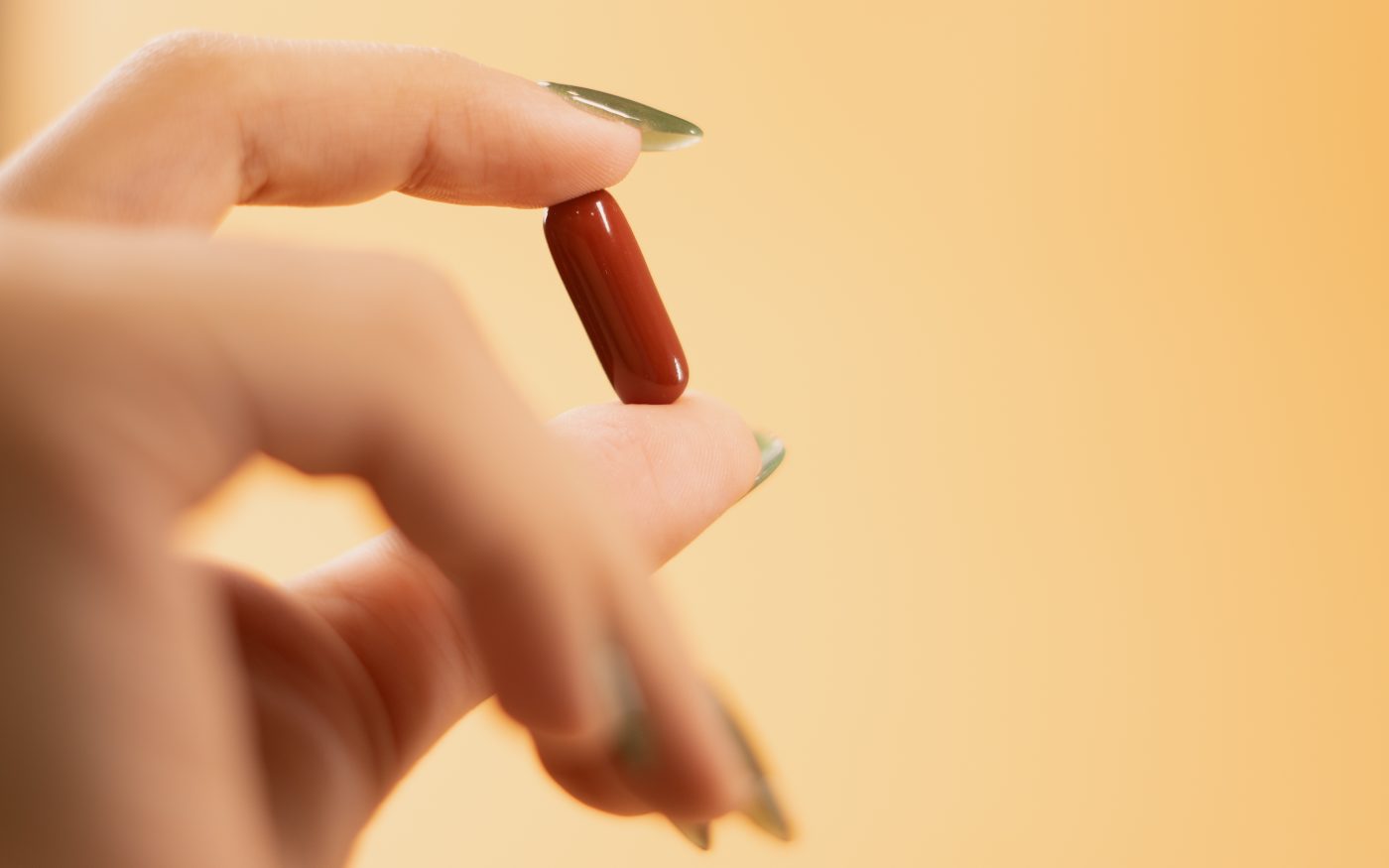 Holding an OXYZ Infinite MSC softgel capsule